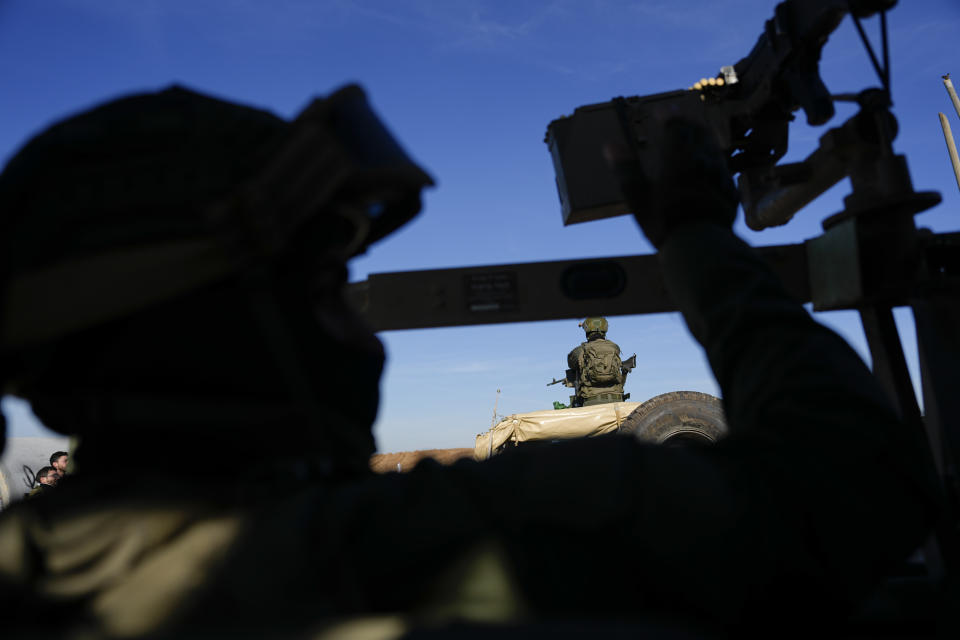 Israeli soldiers drive during a ground operation towards a tunnel underneath UNRWA compound, where the military discovered tunnels in the main headquarters of the U.N. agency that the military says Hamas militants used to attack its forces during a ground operation in Gaza, Thursday, Feb. 8, 2024. The Israeli military says it has discovered tunnels underneath the main headquarters of the U.N. agency for Palestinian refugees in Gaza City, alleging that Hamas militants used the space as an electrical supply room. The unveiling of the tunnels marked the latest chapter in Israel's campaign against the embattled agency, which it accuses of collaborating with Hamas. (AP Photo/Ariel Schalit)