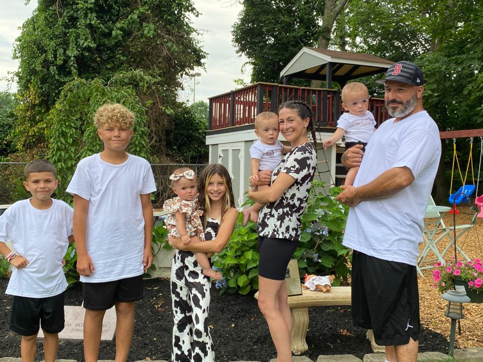 The Ness-Bettencourt family, from left, older sons Zayden and Isaiah; older daughter Chanel holding baby Chatham; mother Ashley Ness and father Val Bettencourt holding their identical twin boys, Cheston and Chance at the Ness-Bettencourt home in Taunton on Saturday, July 29, 2023, for the first birthday party for Cheston, Chance, and Chatham.