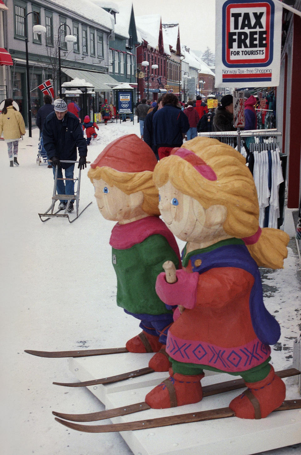 The wooden mascots of the Winter Olympics watch over one of the main shopping streets on Feb. 8, 1994, in Lillehammer, Norway. (AP Photo/Michel Euler)