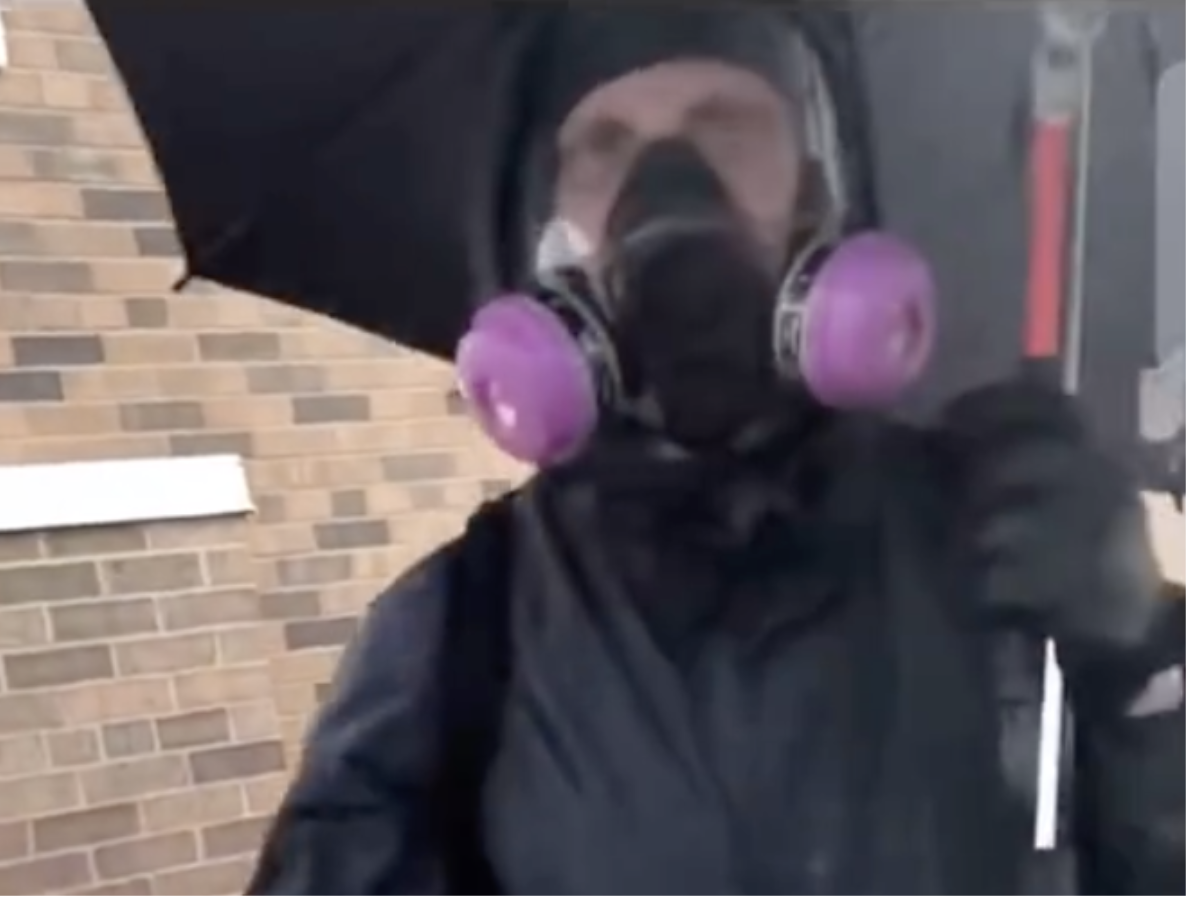 A man dressed in a gas mask and holding an umbrella who was filmed calmly smashing windows. Some have suggested he may have been an agent provocateur