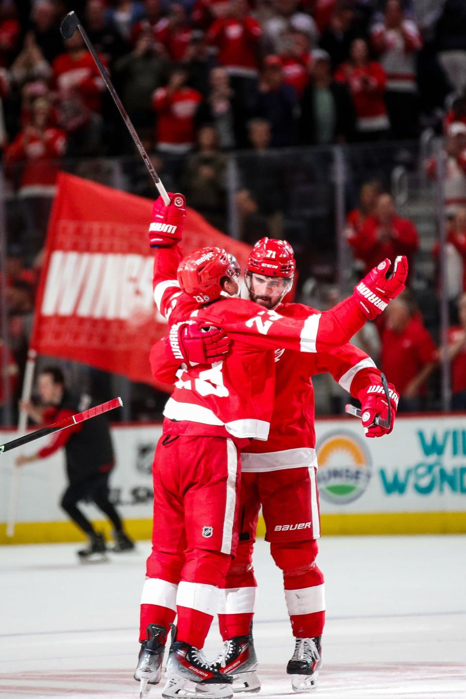 Detroit Red Wings left wing Lucas Raymond (23) hugs center Dylan Larkin (71) after scoring the winning goal for the Red Wings to beat Montreal Canadiens 5-4 in overtime at Little Caesars Arena in Detroit on Monday, April 15, 2024.