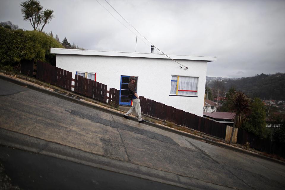 A man walks down Baldwin Street in Dunedin, New Zealand, Monday, Sept. 12, 2011. Baldwin Street is considered one of the world's steepest residential streets. (AP Photo/Natacha Pisarenko)