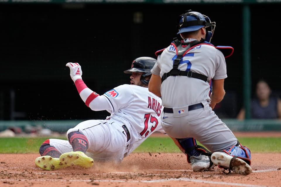 Cleveland Guardians' Gabriel Arias (13) steals home to score behind Los Angeles Dodgers catcher Austin Barnes, right, Thursday in Cleveland.