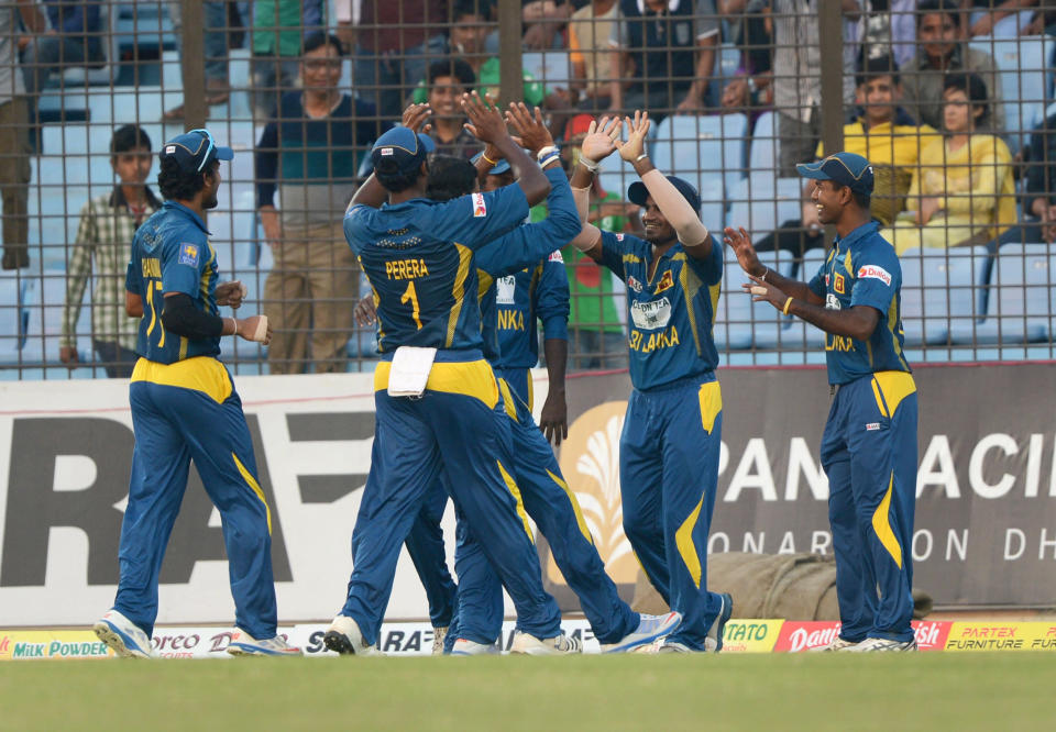 Sri Lankan cricketers celebrate the dismissal of Bangladeshi batsman Anamul Haque during the second T20 cricket match between Bangladesh and Sri Lanka at The Zahur Ahmed Chowdhury Stadium in Chittagong on February 14, 2014. AFP PHOTO/ Munir uz ZAMAN