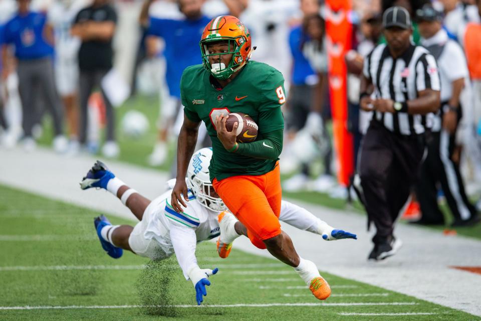 Florida A&M Rattlers running back Kelvin Dean (9) sprints toward the end zone as a defender grabs his ankles during a game against West Florida, Saturday, Sept. 16, 2023.