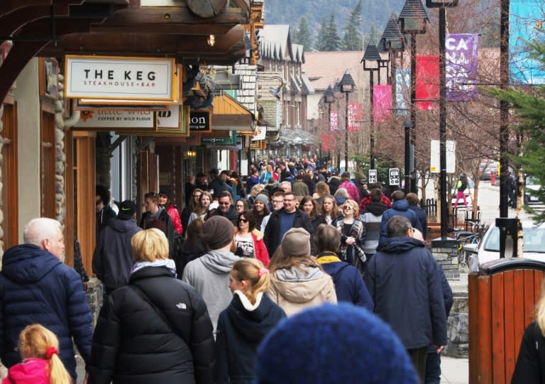 People stroll through the town of Banff inside Banff National Park, Alberta. Canada's national parks contribute Can$1.5 billion (US$1.1 billion) annually to the economy