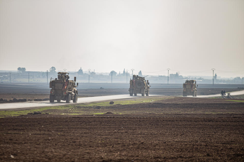 FILE - US military vehicles on a patrol in the countryside near the town of Qamishli, Syria, Sunday, Dec. 4, 2022. U.S. and Kurdish-led forces had arrested an Islamic State group militant in eastern Syria. The Kurdish-led Syrian Democratic Forces said in a statement Monday, Dec. 19, 2022 that they raided the home of an unnamed IS militant leader in the western countryside of Deir el-Zour and arrested him. (AP Photo/Baderkhan Ahmad, File)