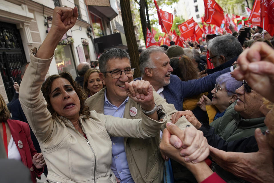 Vice-President of the Spanish Government and Minister of Finance, María Jesús Montero and others government members, cheer to supporters of Spain's Prime Minister Pedro Sánchez gather at the PSOE party headquarter during a demonstration in Madrid, Spain, Saturday, April 27, 2024. Spain is in nail-biting suspense Monday as it waits for Prime Minister Pedro Sánchez to announce whether he will continue in office or not. Sánchez, 52, shocked the country on Thursday, announcing he was taking five days off to think about his future after a court opened preliminary proceedings against his wife on corruption allegations. (AP Photo/Andrea Comas)