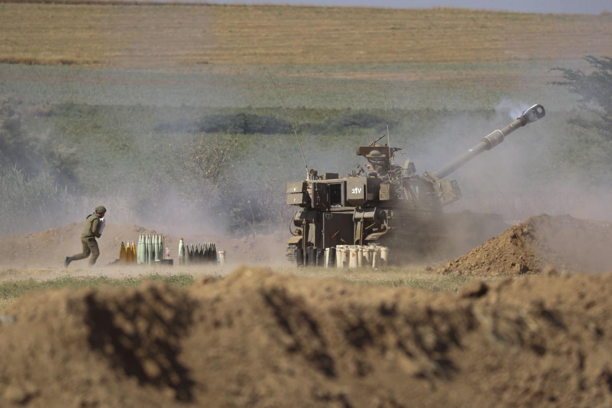 An Israeli artillery unit fires toward targets in the Gaza Strip at the Israel-Gaza border on Saturday, May 15, 2021.