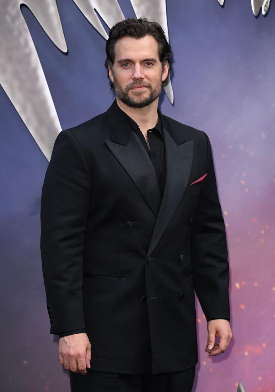 henry cavill at the witcher season 3 premiere in june 2023 in a black suit with a black shirt