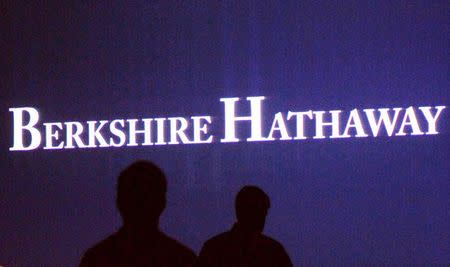 Berkshire Hathaway shareholders walk by a video screen at the company's annual meeting in Omaha May 4, 2013. REUTERS/Rick Wilking/File Photo