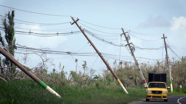 Power lines hang precariously on Oct. 14, 2017, on the side of a road near San Isidro, Puerto Rico, about two weeks after Hurricane María devastated the island. (Photo: Miami Herald via Getty Images)