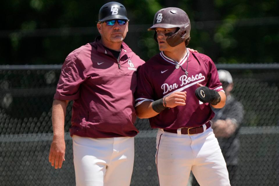Don Bosco Baseball Head Coach, Mike Rooney, greets Andy Granatell at third base.  Granatell would go on to score the first run of the game, in the second inning. Sunday, May 28, 2023 