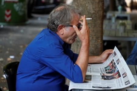 A man reads a newspaper with news of the Government crisis and the resignation of the Prime Minister Giuseppe Conte.