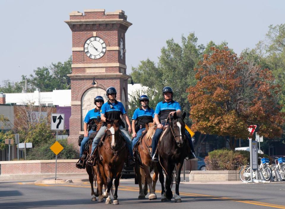 Sgt. Vanessa Rusco, front left, Assistant Commander of the Wichita Police Department Mounted Unit, leads her team in a training event on Douglas in Delano on Wednesday. The Mounted Unit teams train every Wednesday. The other members are Sgt. Mike Roets, Ofr.Joe Dulohery and Det. Arleen Vogt red beard. Chancer, the Belgian Draft horse Sgt. Rusco is riding is in the newest horse on the team and was adopted from Hope in the Valley.