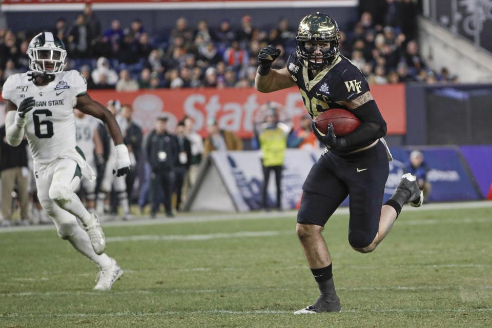 Wake Forest's Jack Freudenthal (86) runs away from Michigan State's David Dowell (6) for a touchdownduring the first half of the Pinstripe Bowl NCAA college football game Friday, Dec. 27, 2019, in New York. (AP Photo/Frank Franklin II)