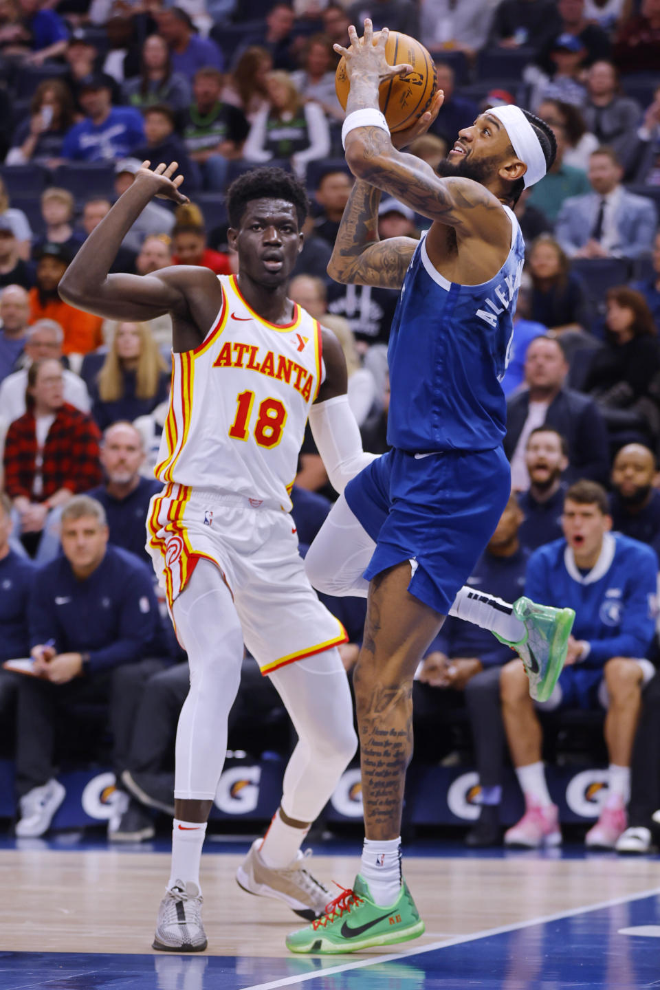 Minnesota Timberwolves guard Nickeil Alexander-Walker, right, shoots after being fouled by Atlanta Hawks forward Mouhamed Gueye (18) during the second quarter of an NBA basketball game Friday, April 12, 2024, in Minneapolis. (AP Photo/Bruce Kluckhohn)