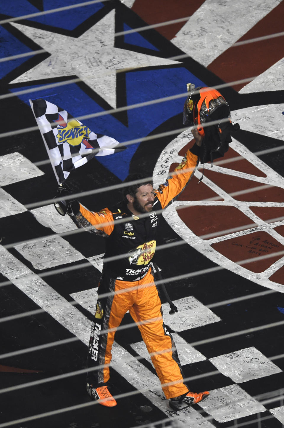 Martin Truex Jr. celebrates after winning the NASCAR Cup Series auto race at Charlotte Motor Speedway in Concord, N.C., Sunday, May 26, 2019. (AP Photo/Mike McCarn)