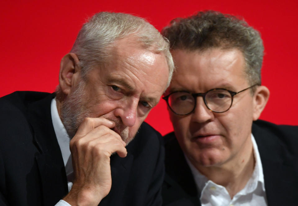 Britain's opposition Labour Party leader Jeremy Corbyn, left, talks with deputy leader Tom Watson during the start of the party's annual conference in Liverpool, England, Sunday Sept. 23, 2018. Britain's Labour Party is facing a huge choice at its annual conference, whether to back a new Brexit referendum on the country's departure from the European Union. (Stefan Rousseau/PA via AP)
