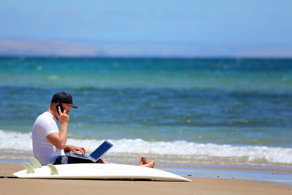 A man working when he should be surfing,