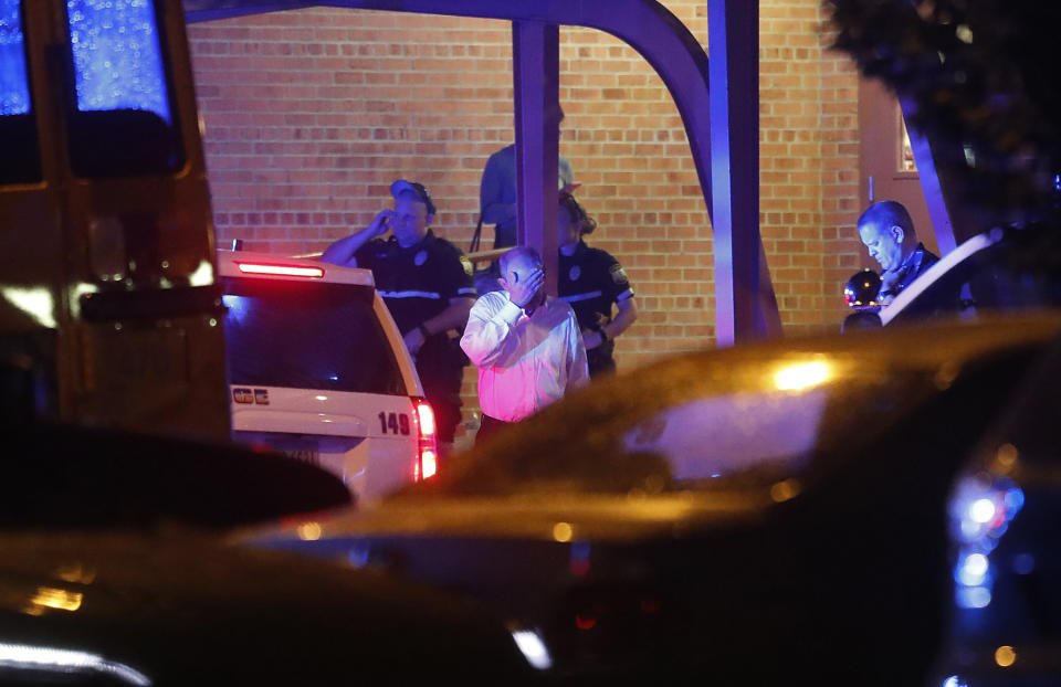 People exit Princess Anne Middle School, where friends and relatives were reuniting with loved ones who were in a building during a shooting, as officers stand outside Friday evening, May 31, 2019, in Virginia Beach, Va. (Photo: Jonathan Gruenke/The Virginian-Pilot via AP)