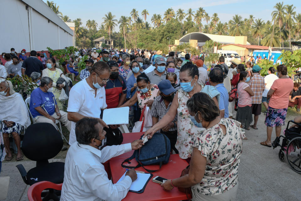 COYUCA DE BENITEZ, MEXICO - APRIL 15: People give their information prior to receive a dose of the CanSino vaccine as part of COVID-19 vaccination on April 15, 2021 in Coyuca de Benitez, Mexico. Vaccination begins today in the regions of Tierra Caliente and some municipalities of Costa Grande, where health authorities will apply the vaccine CanSino, which is a single dose to adults over 60 years of age. (Photo by Karen Melo/gencia Press South/Getty Images)