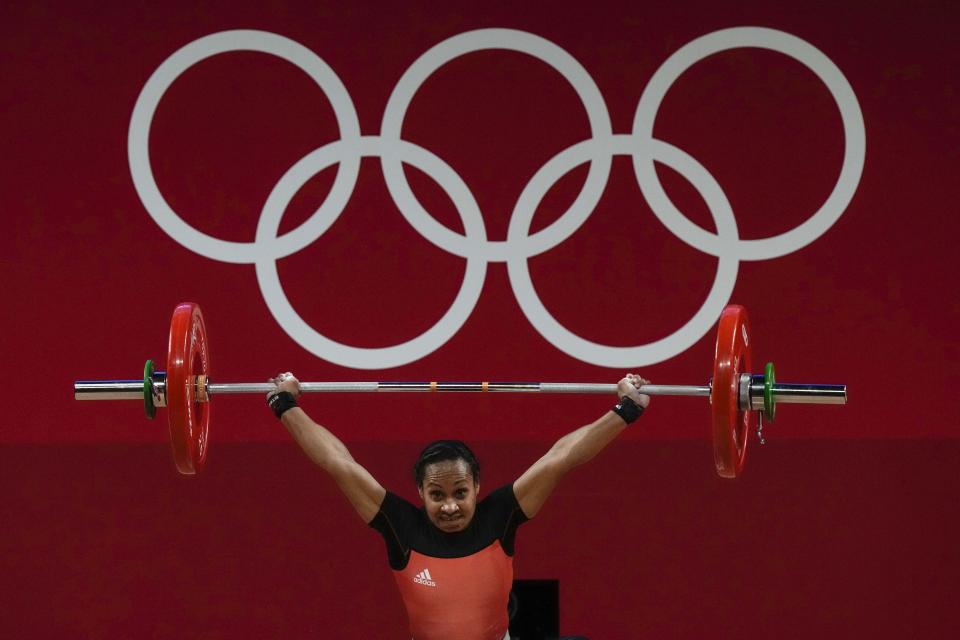 Loa Dika Toua of Papa New Guinea competes in the women's 49kg weightlifting event, at the 2020 Summer Olympics, Saturday, July 24, 2021, in Tokyo, Japan. (AP Photo/Luca Bruno)