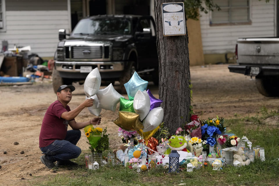 FILE - A man releases a balloon from the makeshift memorial outside the victims' home Tuesday, May 2, 2023, where a mass shooting occurred Friday, in Cleveland, Texas. A 38-year-old man was arrested after a four-day manhunt. Authorities allege that the man charged into a neighbor's home and killed five people, including a 9-year-old boy, after his neighbors asked him to stop firing his AR-style rifle because a baby was trying to sleep. (AP Photo/David J. Phillip, File)