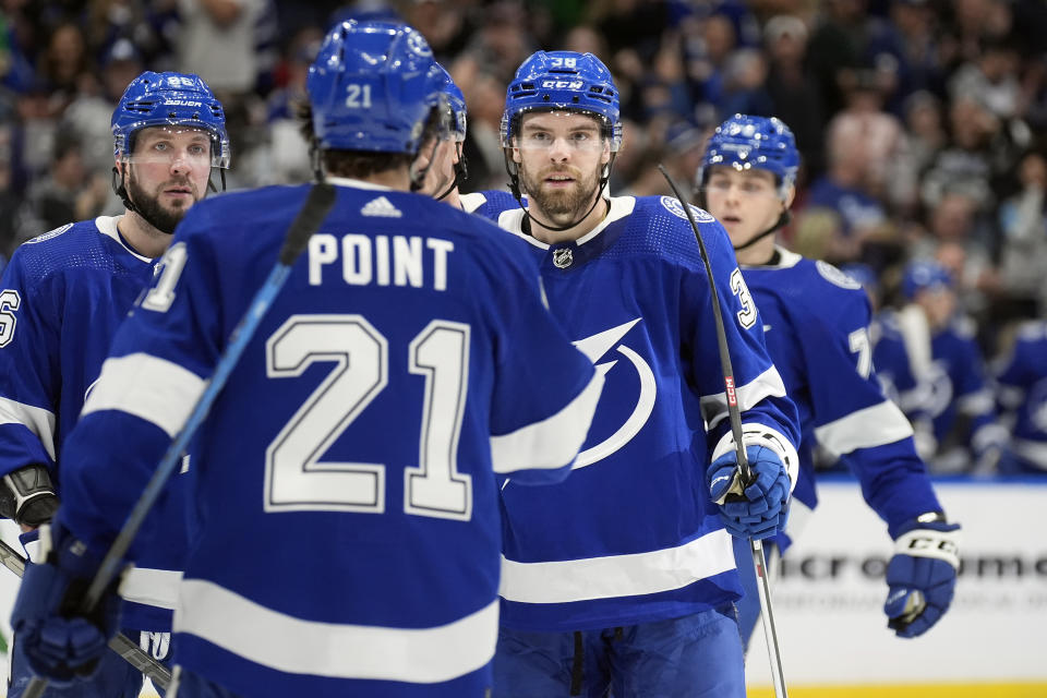 Tampa Bay Lightning left wing Brandon Hagel (38, second from right) celebrates his goal against the Washington Capitals with center Brayden Point (21) and right wing Nikita Kucherov (86) during the second period of an NHL hockey game Thursday, Feb. 22, 2024, in Tampa, Fla. (AP Photo/Chris O'Meara)