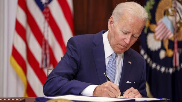 PHOTO: President Joe Biden signs the Bipartisan Safer Communities Act into law in the Roosevelt Room of the White House, June 25, 2022. The legislation is the first new gun regulations passed by Congress in more than 30 years. (Tasos Katopodis/Getty Images, FILE)