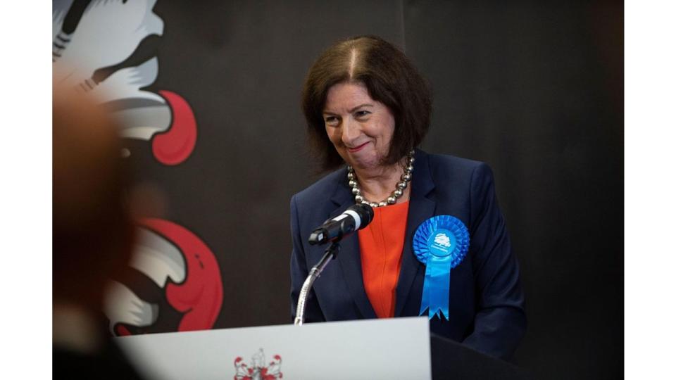 Jo Gideon at a podium giving a victory speech