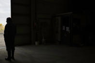 Bart Dochy looks out of a barn door at his family farm in Ledegem, Belgium, Tuesday, Feb. 13, 2024. Because rules change so fast, Dochy said it becomes harder and harder to invest wisely. In Northern Belgium such issues have coalesced around nitrate poolution and rules to contain them. (AP Photo/Virginia Mayo)