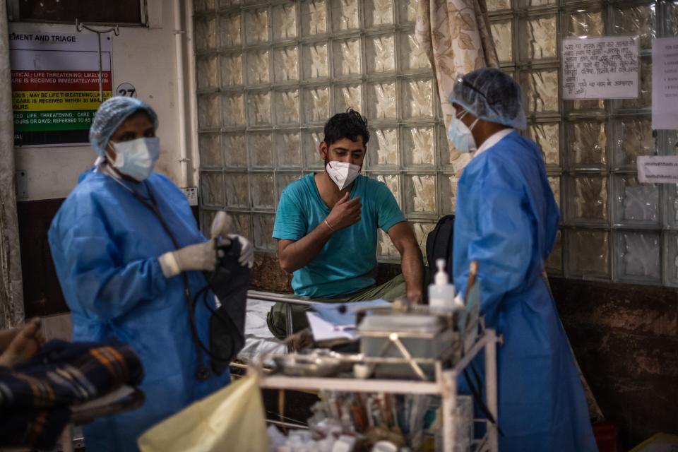 <p>Medical staff attend to Covid-19 positive patients in the emergency ward of a hospital in Delhi, India, 6 May, 2021</p> (Getty Images)