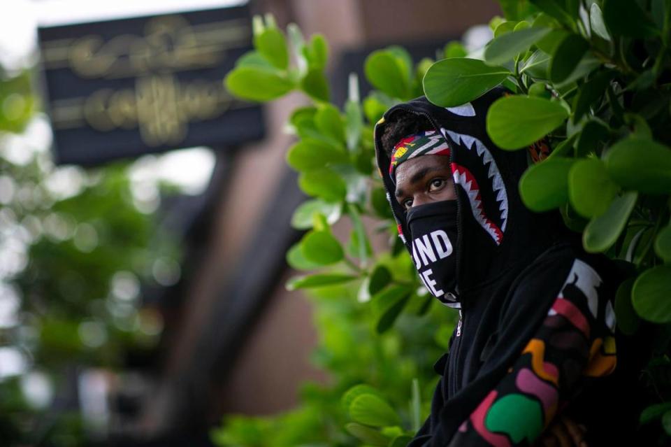 An activist listens to speakers during an Abolish the Police rally at Panther Coffee in MiamiÕs Wynwood neighborhood on Saturday, June 20, 2020.