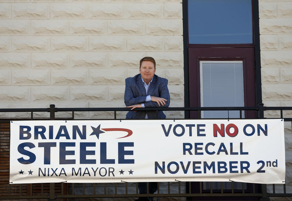 Brian Steele, Mayor of Nixa, is seen next to one of his campaign signs in Nixa, Missouri on Oct. 21,2021. Steele is facing a recall election on November 2nd as a local conservative group has taken issue with some of the cities COVID-19 measures taken in the past year. (AP Photo/Bruce E. Stidham)