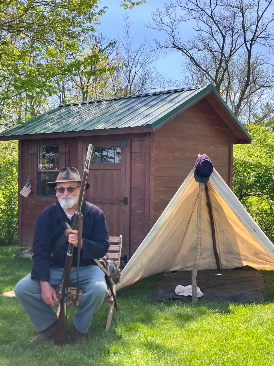 John Cauvel, who is one of the historians who shares knowledge of the Civil War during Cabin at Willow Hollow History Days, sits in front of a tent on the grounds.