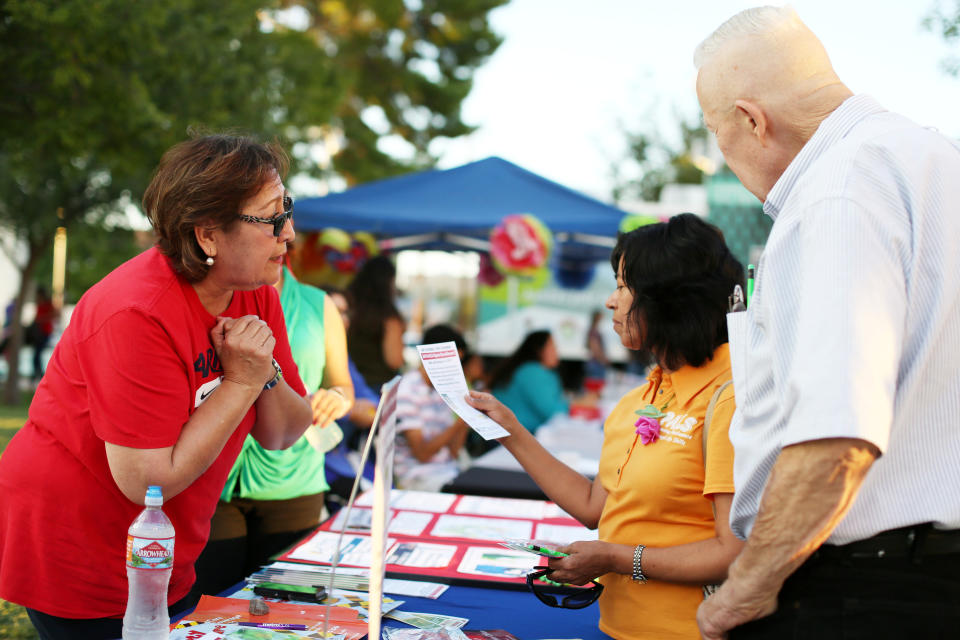 University of Arizona Center for Rural Health navigator Maria Losoya gives people information and answers on health insurance at the Celebración de la Independencia de Mexico in Tucson, Ariz., in September. (Photo: Caitlin O’Hara/Reuters)