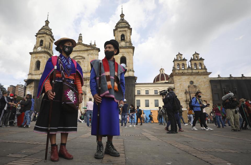 Guambiano Indigenous people arrive to Bolivar square for a protest against the government in Bogota, Colombia, Monday, Oct. 19, 2020. The leaders of the indigenous communities say they are mobilizing to reject massacres, assassinations of social leaders, criminalization of social protest, to defend their territory, democracy and peace, and plan to stay in the capital for a nationwide protest and strike on Oct. 21. (AP Photo/Fernando Vergara)