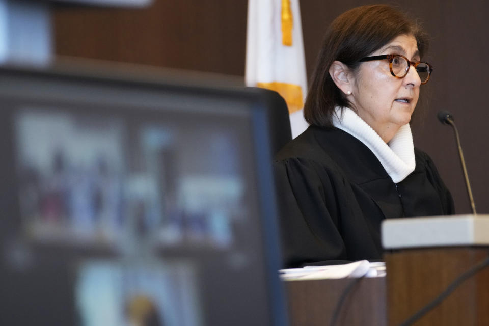 Judge Victoria A. Rossetti asks questions to Robert E. Crimo III., during a case management conference at the Lake County Courthouse Monday, Dec. 11, 2023, in Waukegan, Ill. Robert Crimo III, accused of killing seven and wounding dozens more at a Fourth of July parade in 2022, asked a Lake County judge to allow him to continue without the aid of his assistant public defenders and invoked his right to a speedy trial. (AP Photo/Nam Y. Huh, Pool)