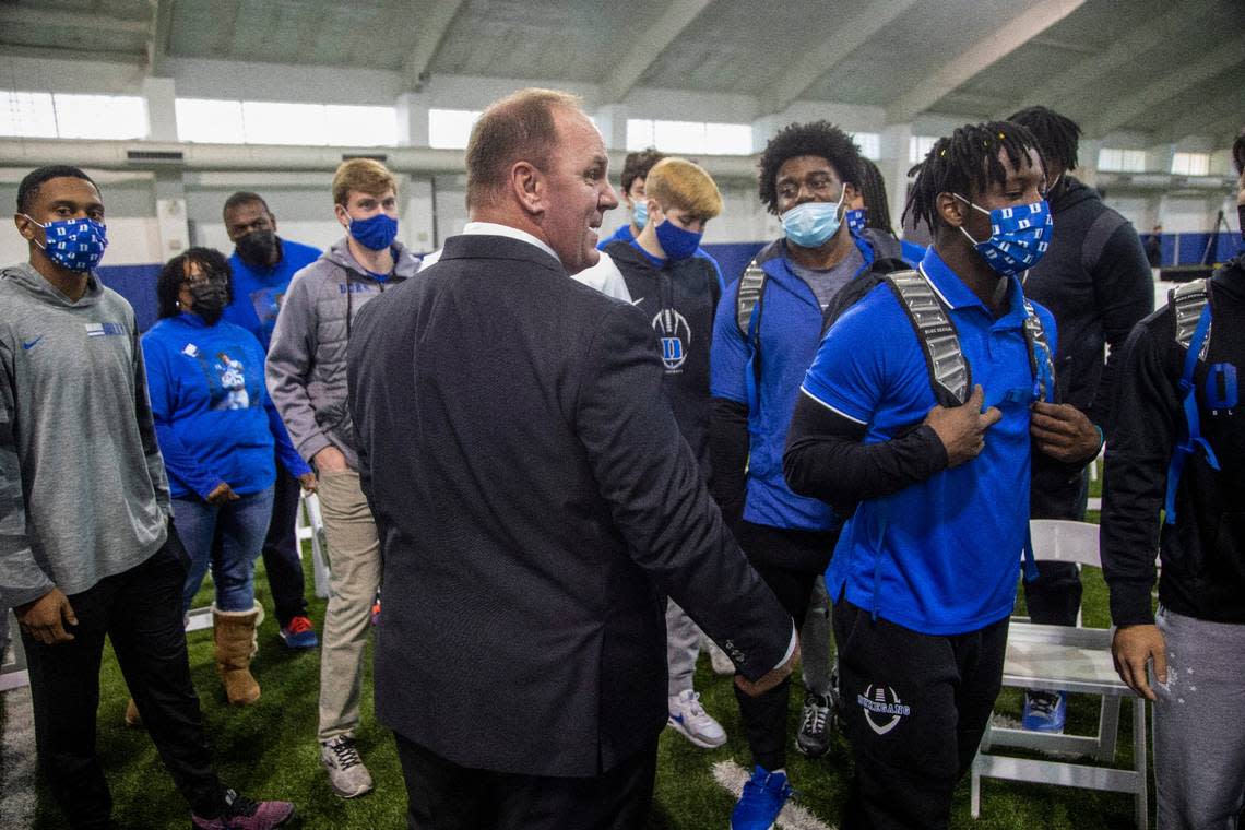 Mike Elko talks with players after being introduced as Duke University’s head football coach during a press conference at Pascal Field House in Durham, Monday, Dec. 13, 2021.