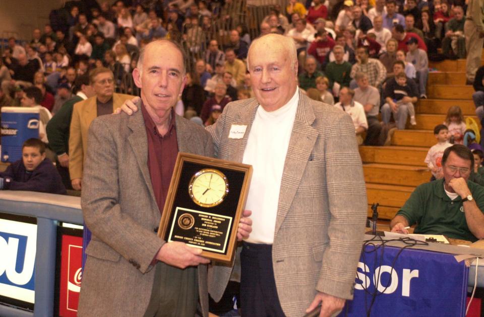 Record sportswriter Bob Kurland is presented with an award honoring his contributions to Bergen basketball by Jamboree Committee member Mickey Corcoran at the Rothman Center in Teaneck, Feb 25, 2001.
