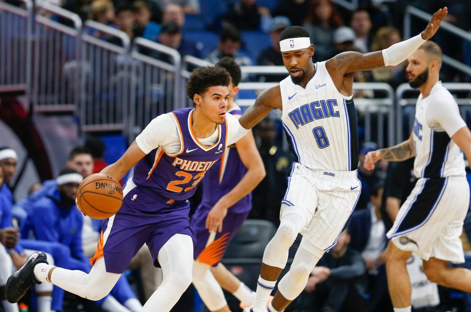 Dec 4, 2019; Orlando, FL, USA; Phoenix Suns forward Cameron Johnson (23) drives around Orlando Magic guard Terrence Ross (8) during the second quarter at Amway Center. Mandatory Credit: Reinhold Matay-USA TODAY Sports