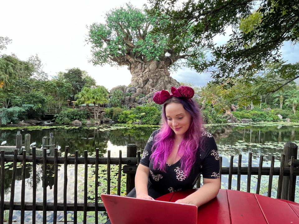 jenna on laptop behind tree of life