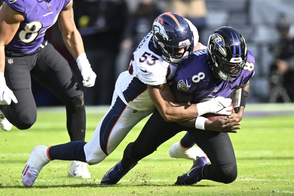 Jonathon Cooper of the Denver Broncos sacks Lamar Jackson, who would leave the game with a knee injury.  (Photo by Greg Fiume/Getty Images)