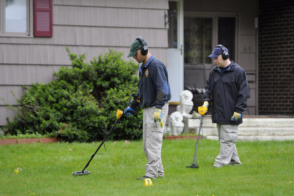 FILE - In this May 10, 2012, file photo, law enforcement agents search the yard at the home of reputed Connecticut mobster Robert Gentile in Manchester, Conn. The chief investigator for a Boston museum still working to recover $500 million worth of art stolen in 1990 said Thursday, Sept. 23, 2021, that he was hoping for new leads to emerge in the case following the recent death of Gentile. (AP Photo/Jessica Hill, File)