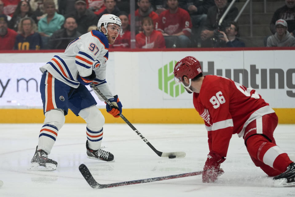 Detroit Red Wings defenseman Jake Walman (96) defends Edmonton Oilers center Connor McDavid (97) as he prepares to shoot in the first period of an NHL hockey game Thursday, Jan. 11, 2024, in Detroit. (AP Photo/Paul Sancya)