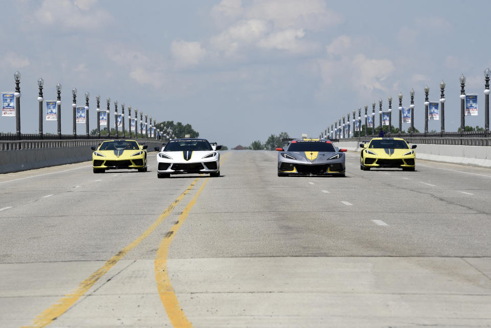 The 2022 Corvette Stingray IMSA GTLM Championship Edition vehicles, left and right, along with a Corvette pace car, center left, and a Corvette C8.R race car, center right, are driven across the MacArthur Bridge toward the Raceway at Belle Isle for a news conference Wednesday, June 9, 2021 in Detroit. (AP Photo/Jose Juarez)