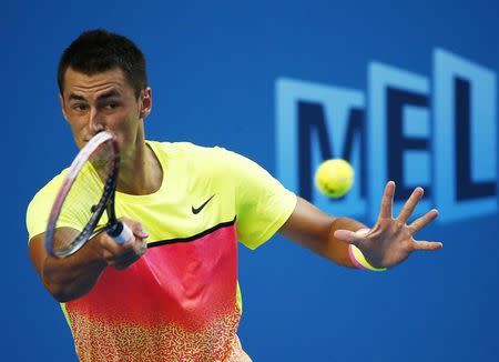 Bernard Tomic of Australia hits a return against Sam Groth of Australia during their men's singles third round match at the Australian Open 2015 tennis tournament in Melbourne January 23, 2015. REUTERS/Thomas Peter