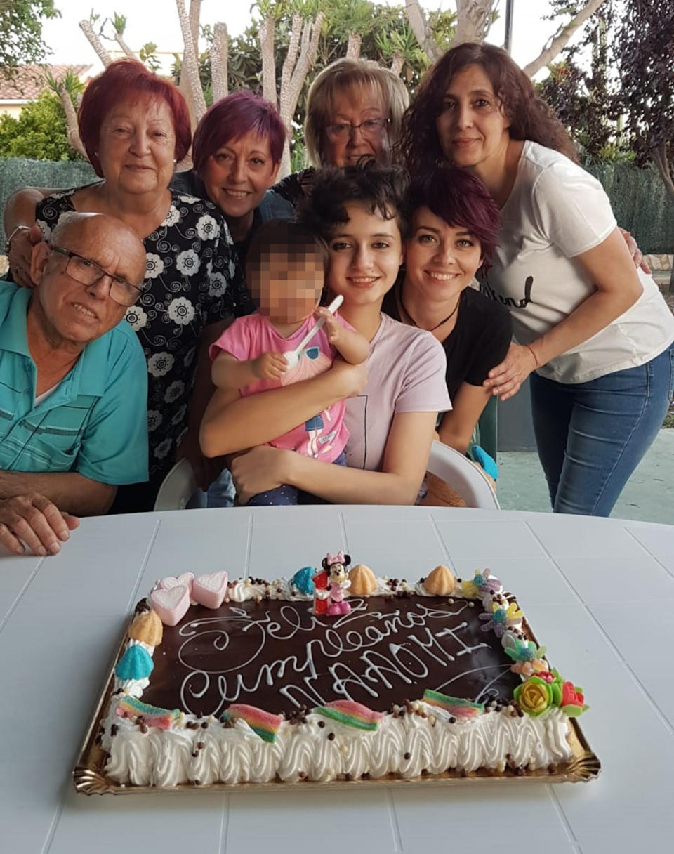 Patricia and her family crowd around a birthday cake for her daughter after she left the cult. Source: Real Press/Australscope