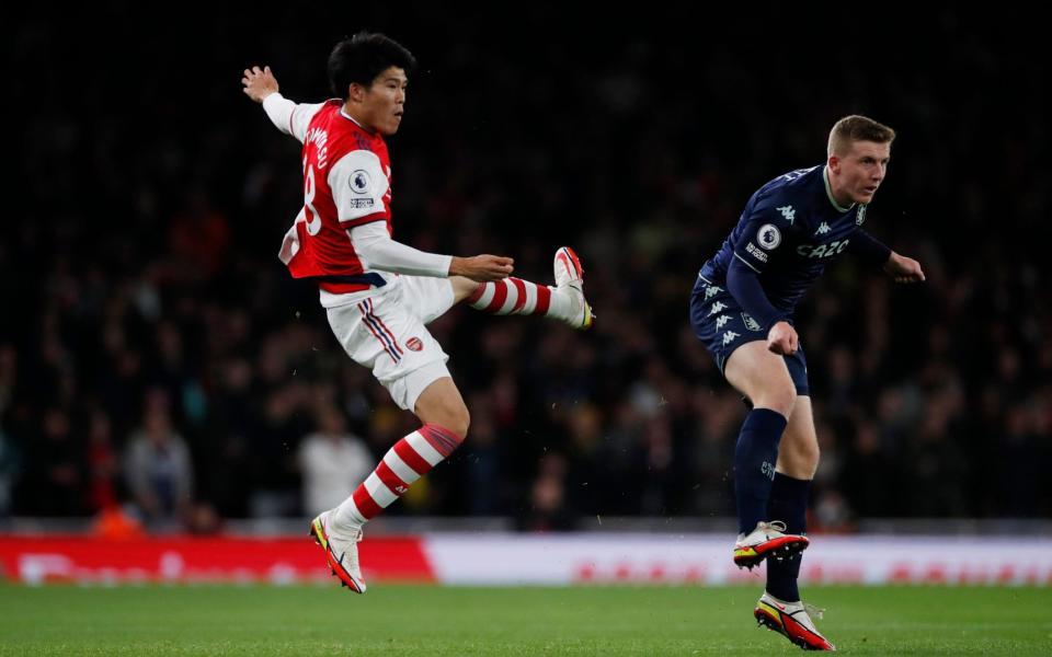 senal's Takehiro Tomiyasu in action with Aston Villa's Matt Targett